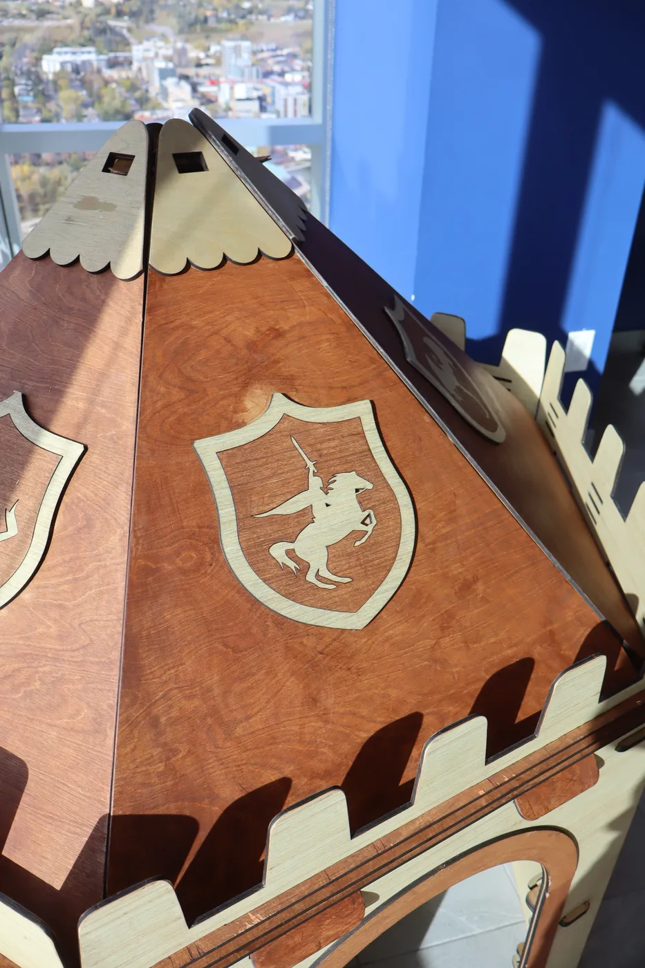 Close-up of the NimoPlay castle playhouse roof with the engraved knight crest